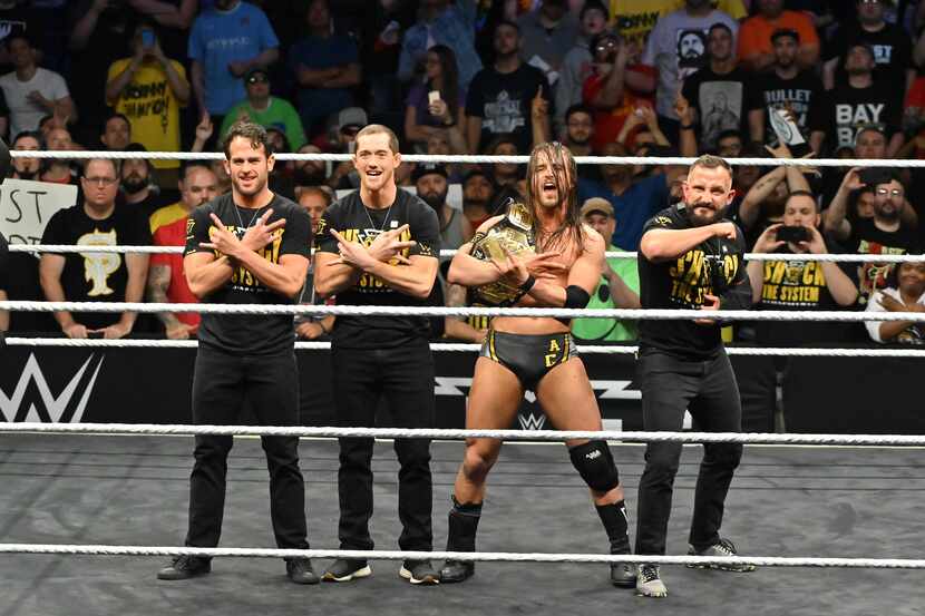 Adam Cole poses with the NXT championship alongside the Undisputed Era.