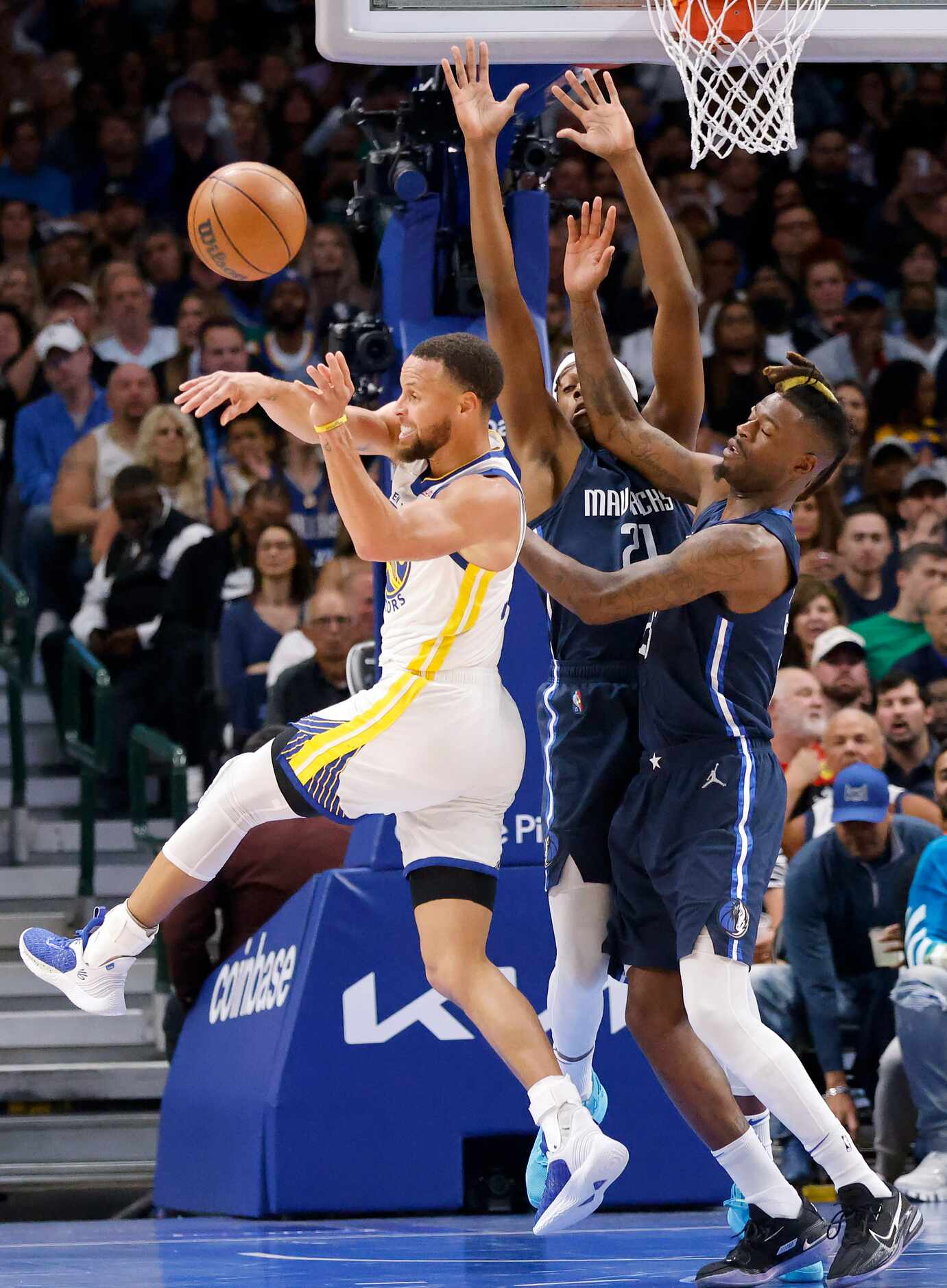 Golden State Warriors guard Stephen Curry (30) kicks the ball out after being double teamed...