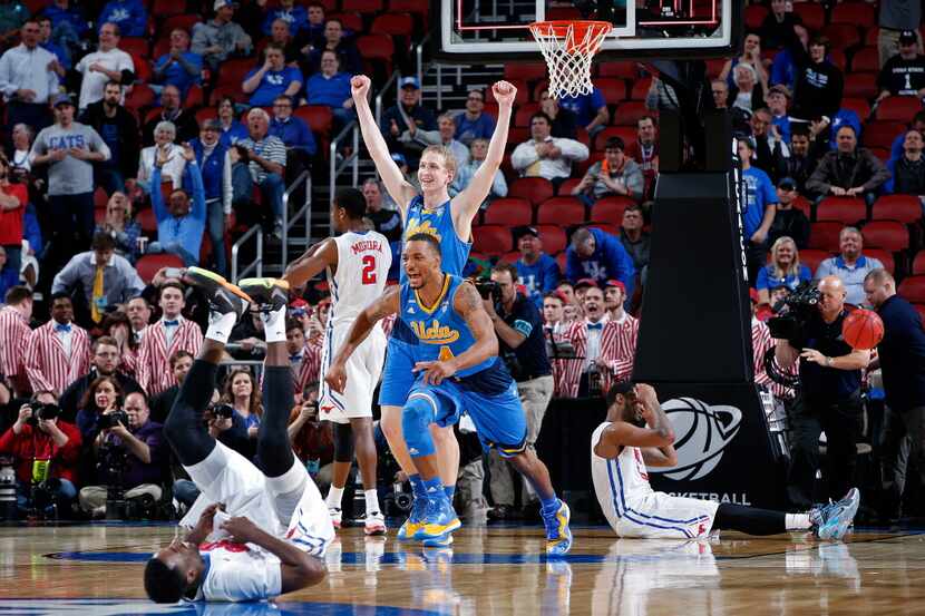 LOUISVILLE, KY - MARCH 19:  Thomas Welsh #40 and Norman Powell #4 of the UCLA Bruins reacts...