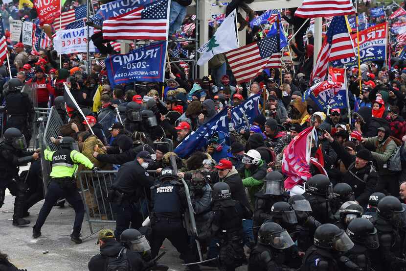 Trump supporters clash with police as they push barricades to storm the U.S. Capitol on Jan....