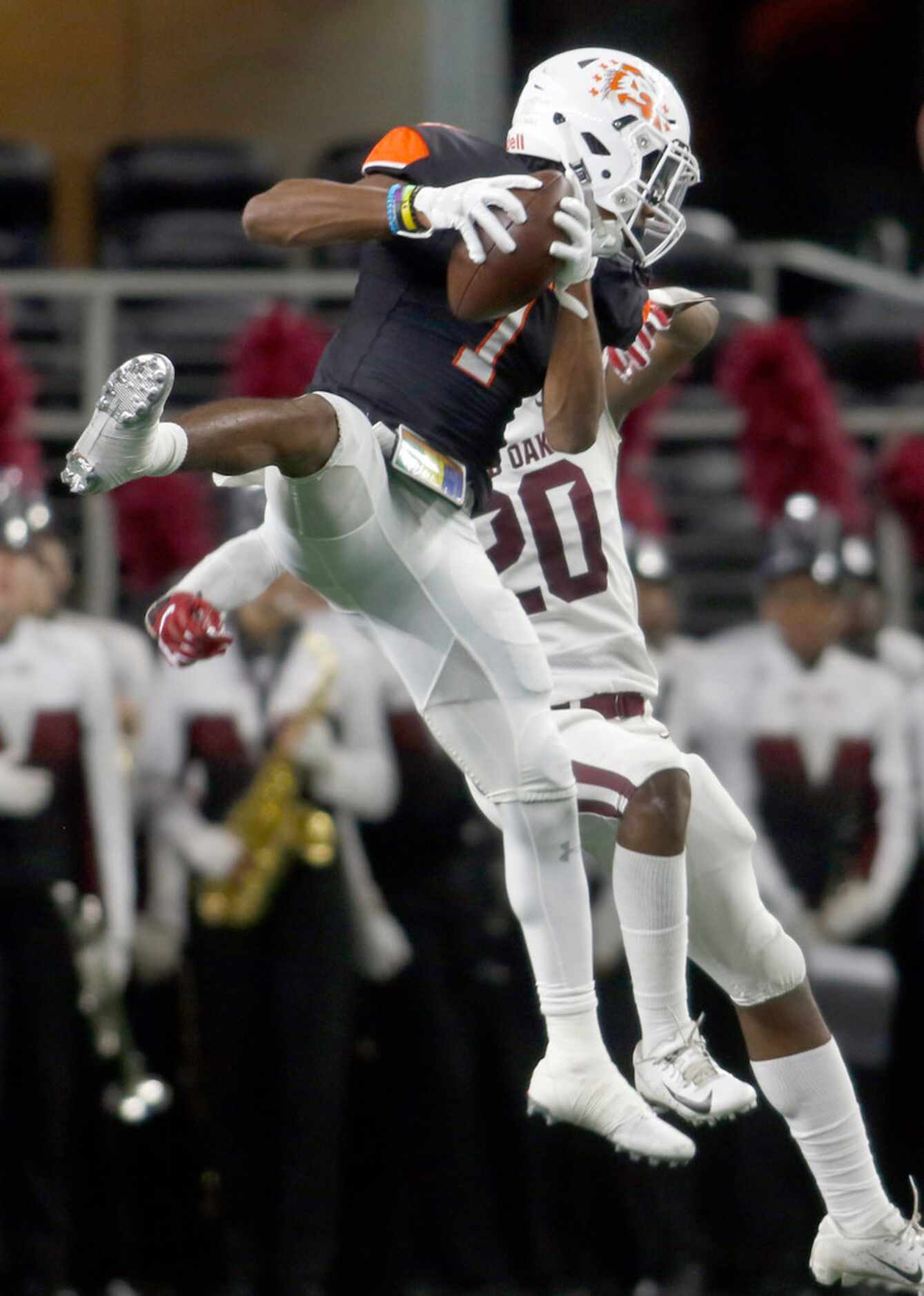 Aledo receiver JoJo Earle (1) skies over the defense of Red Oak defensive back Elijah Shaw...