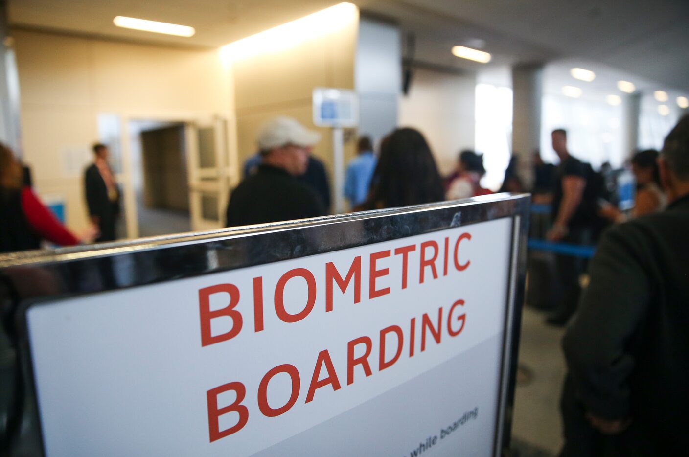 Passengers board an American Airlines flight to Tokyo Narita International Airport using...