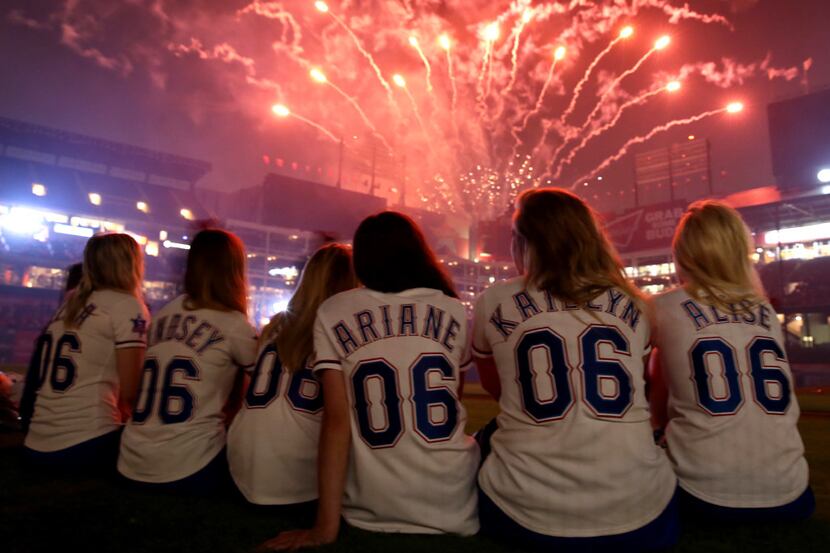 The Texas Rangers Six Shooters watch the fireworks show after the Rangers' 6-3 loss to the...