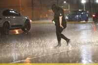 A woman walk in the rain, Wednesday, Oct. 4, 2023 in Dallas.  (File Photo)