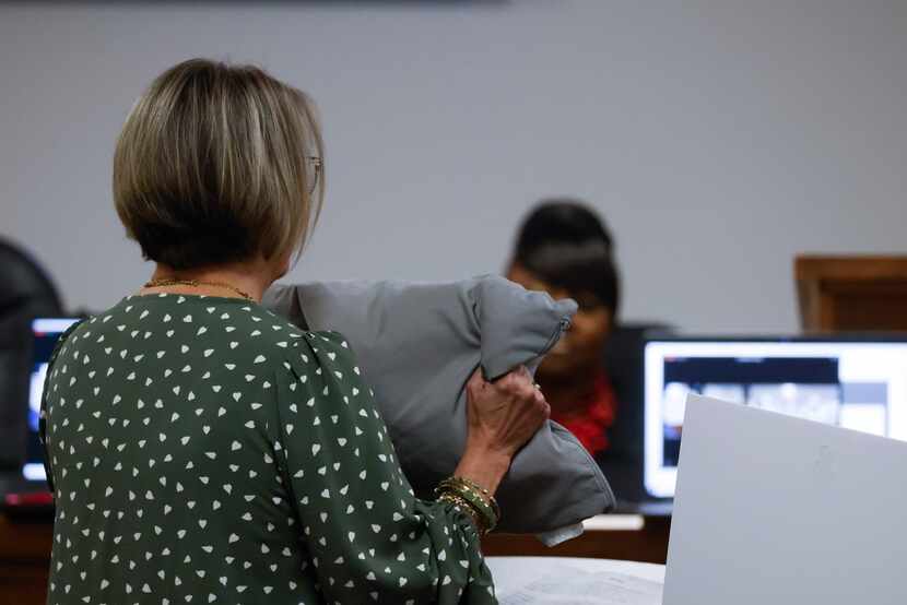 Diana Tannery, daughter of victim Juanita Purdy shows a pillow toward accused serial killer...