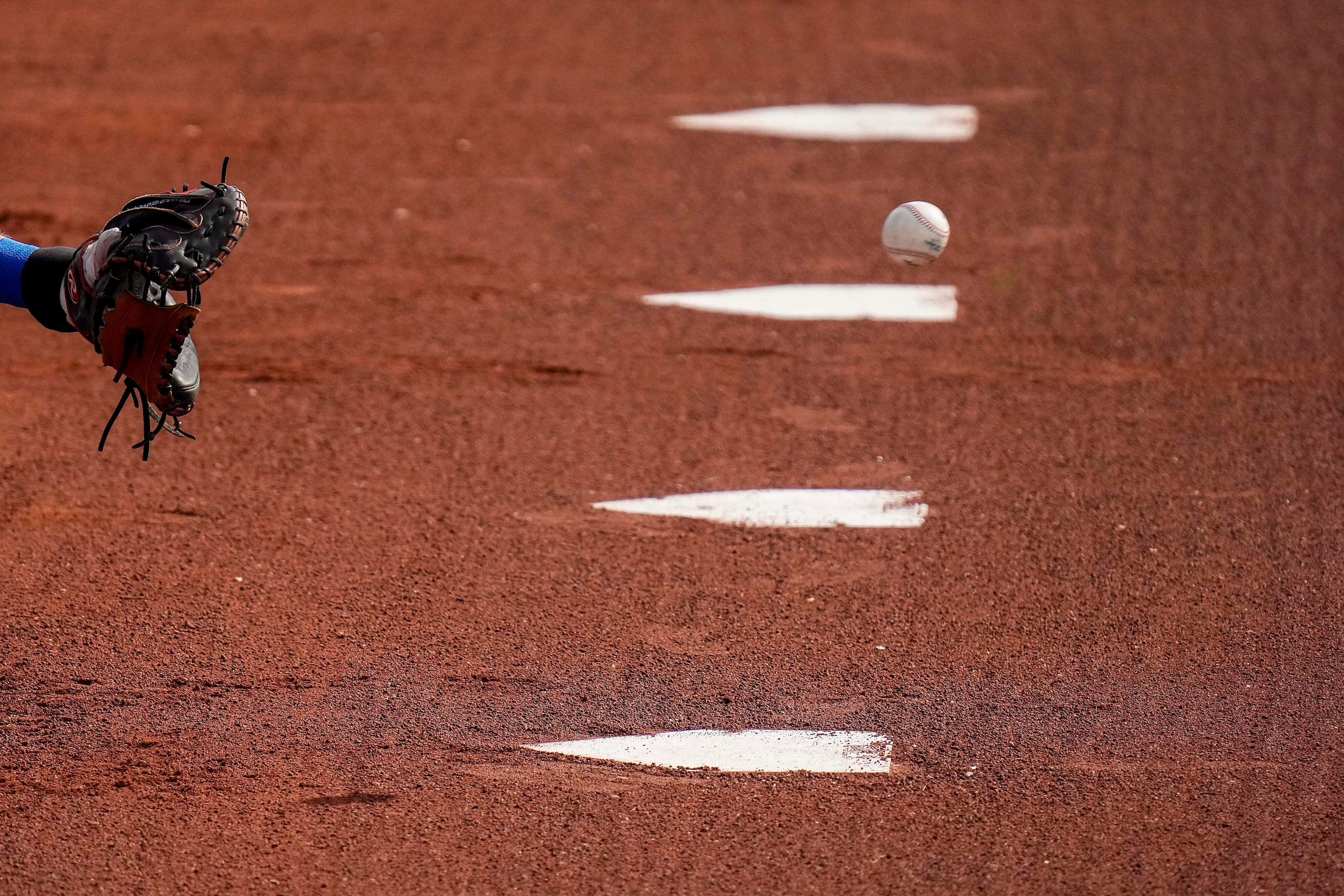 Texas Rangers catcher Sam Huff catches in the bullpen during a spring training workout at...