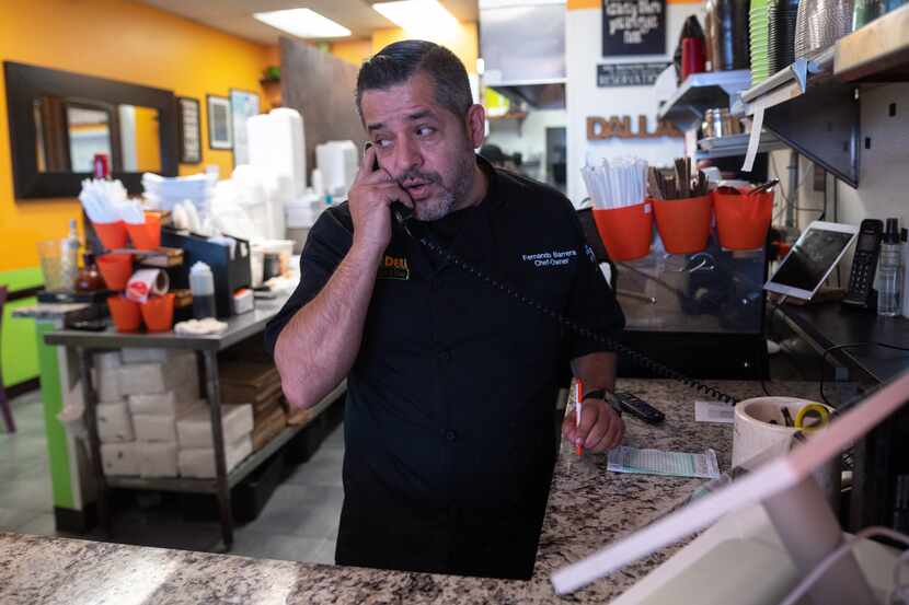 Chef and owner Fernando Barrera speaks with a client about a food order at this restaurant...
