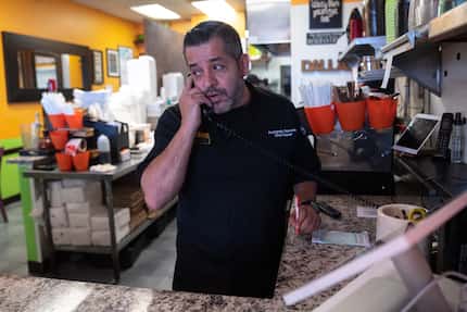 Chef and owner Fernando Barrera speak with a client about a food order at this restaurant...