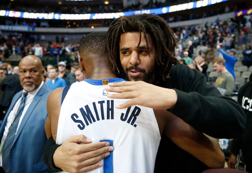 Dallas Mavericks guard Dennis Smith Jr. (1) and musical artist J. Cole meet up after the...