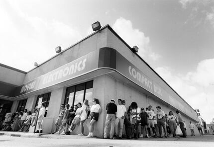 July 11, 1992: A line  snakes around the Sound Warehouse at 5475 Greenville Ave. as fans...