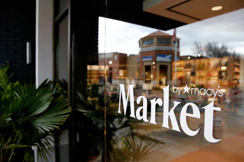 Southlake Town Square is reflected in the front entrance of the Market by Macy's in the...