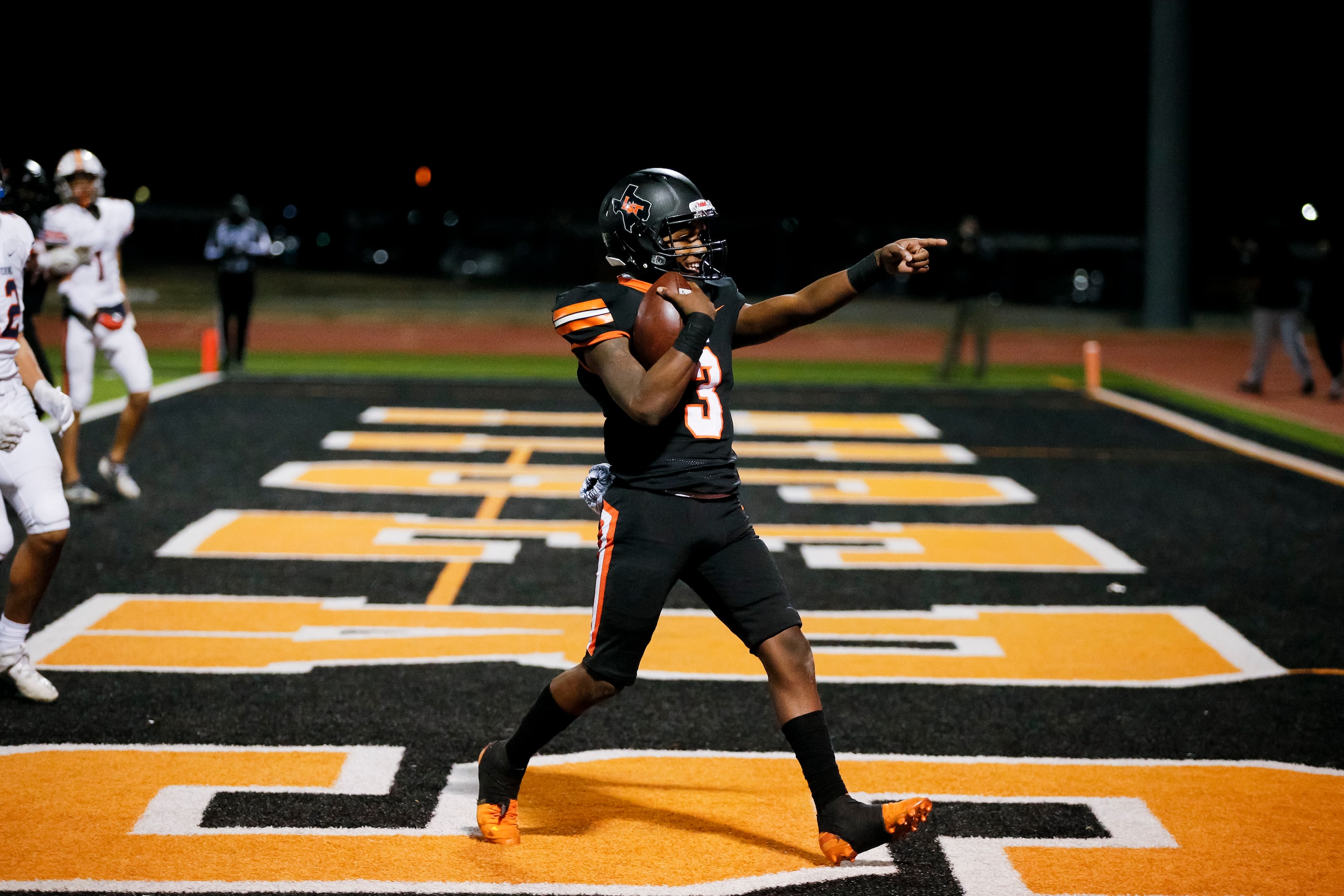 Lancaster junior quarterback Glenn Rice Jr. (3) celebrates scoring a touchdown during the...