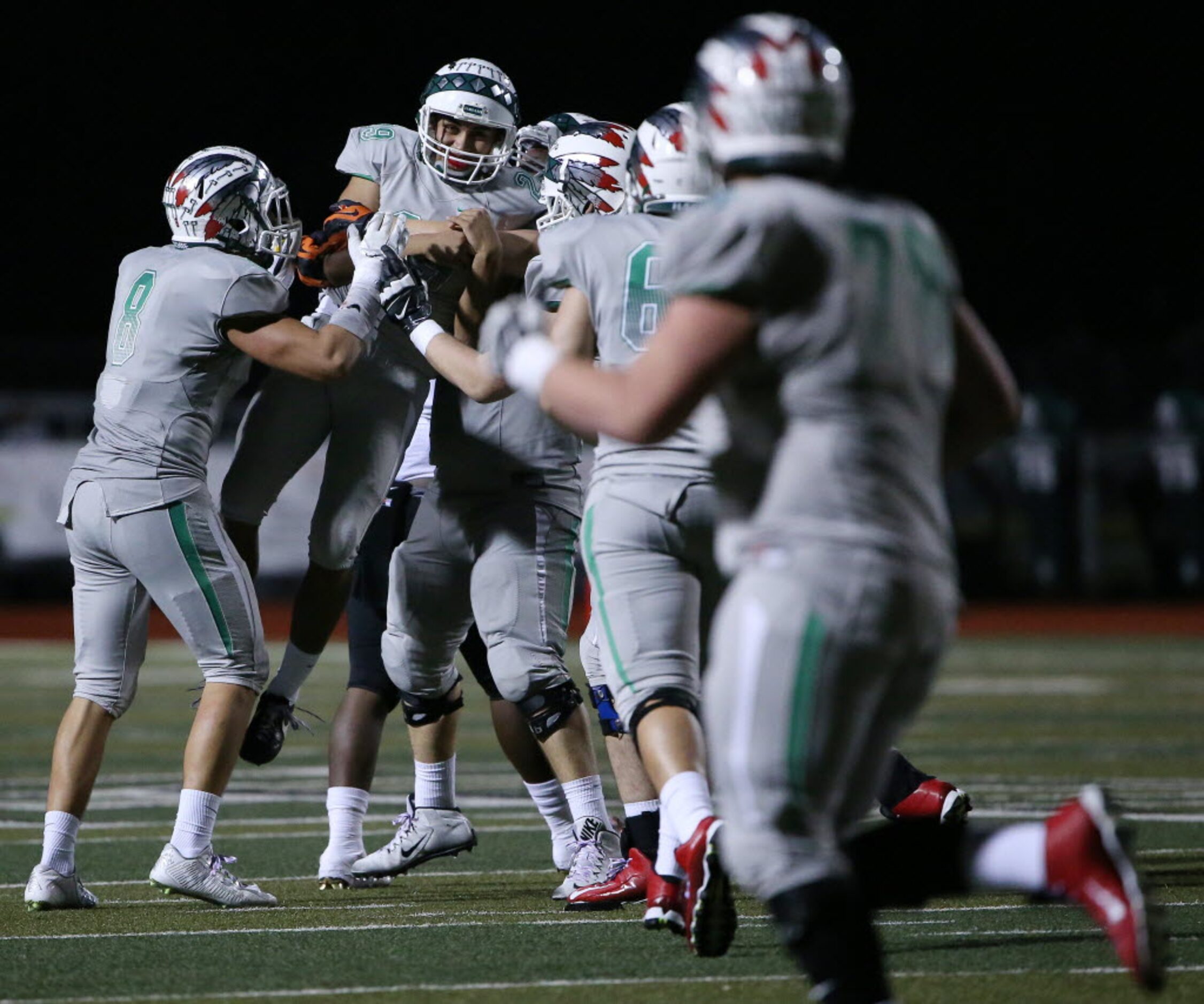 Waxahachie kicker Roberto Perez (29) is met by teammates after hitting a 46-yard field goal...