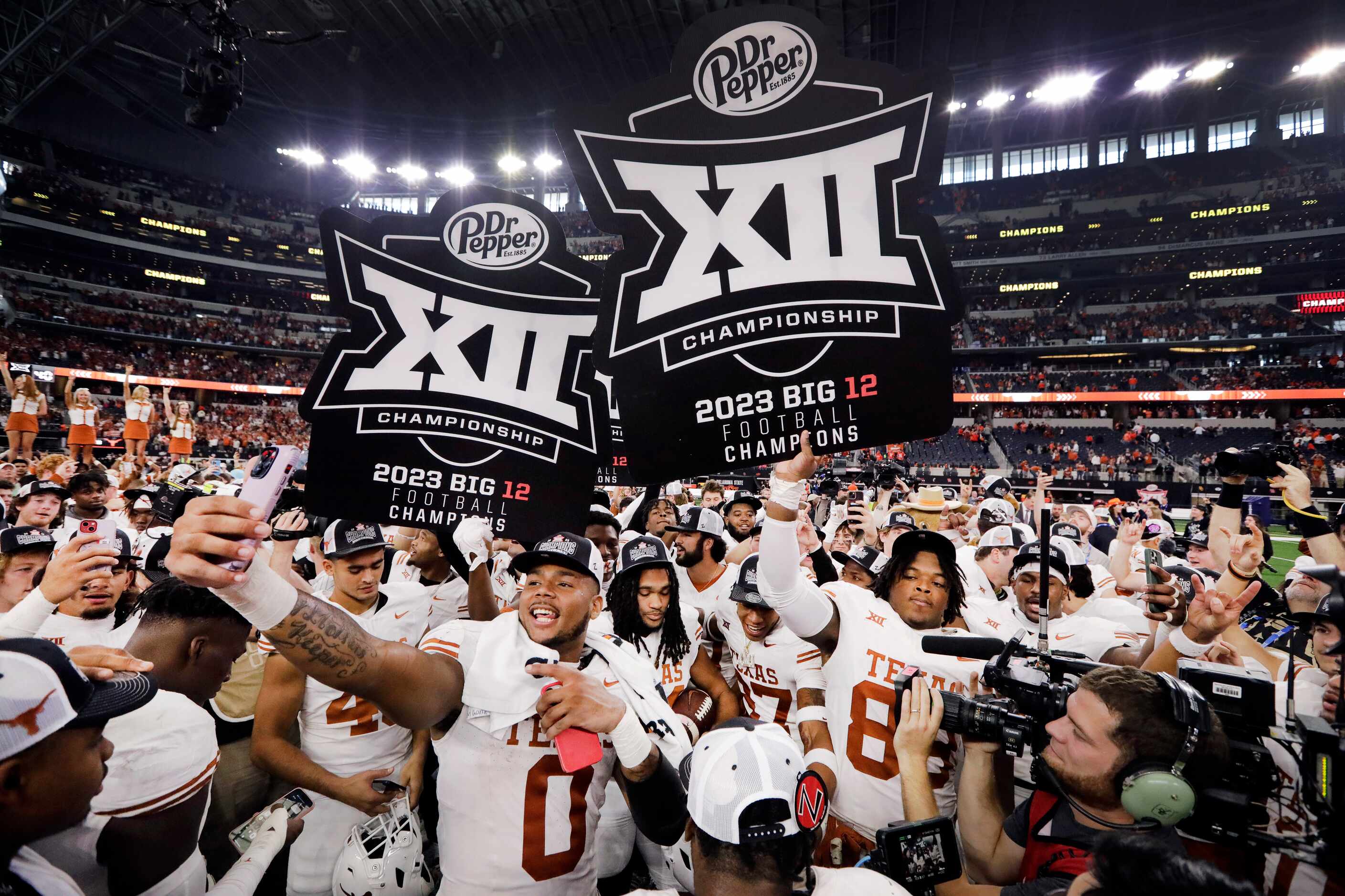 Texas Longhorns celebrate their Big 12 Championship win over the Oklahoma State Cowboys at...