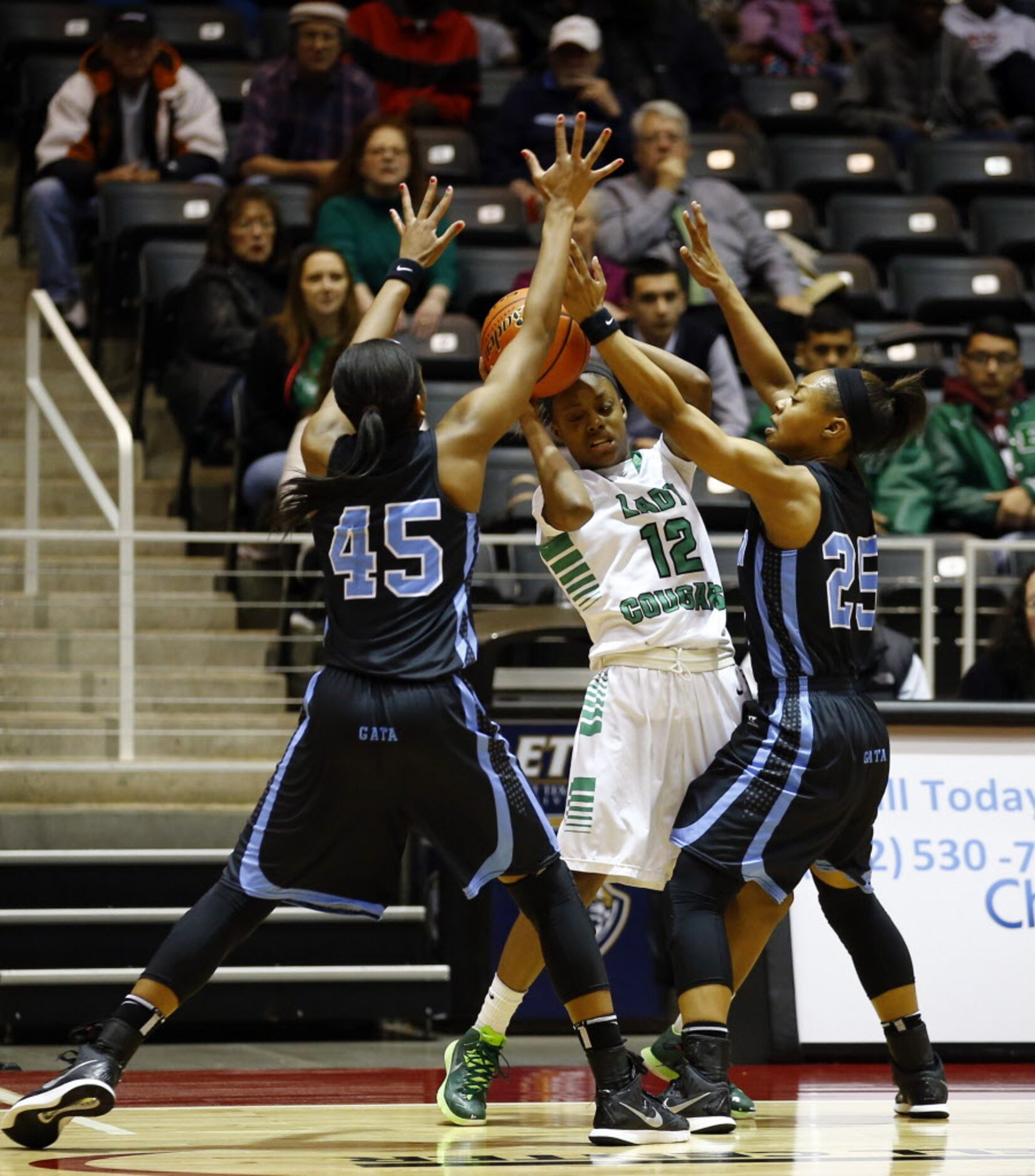 Bryan Adams' Alexxus Gilbert (12) is pressured by Arlington Seguin's Alarie Mayze (45) and...