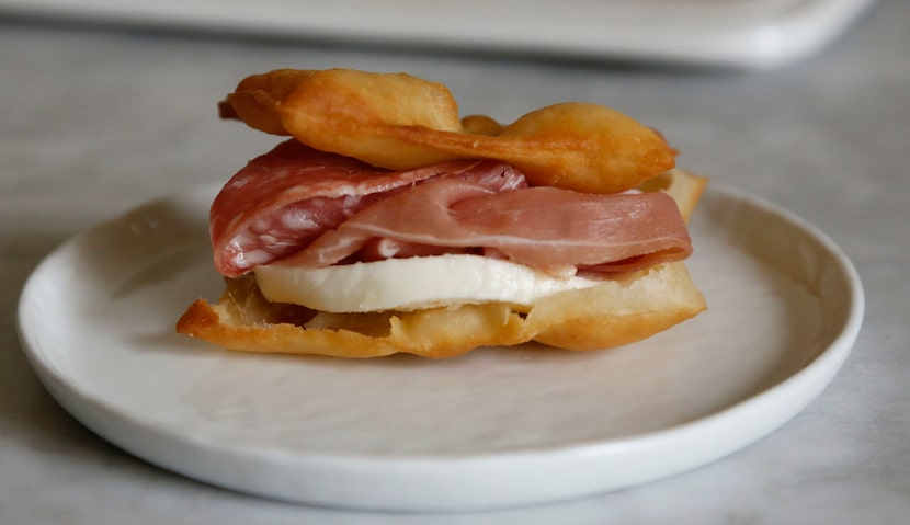 Gnocco grotto is a traditional Italian dish made of fried dough served with salumi or cold...