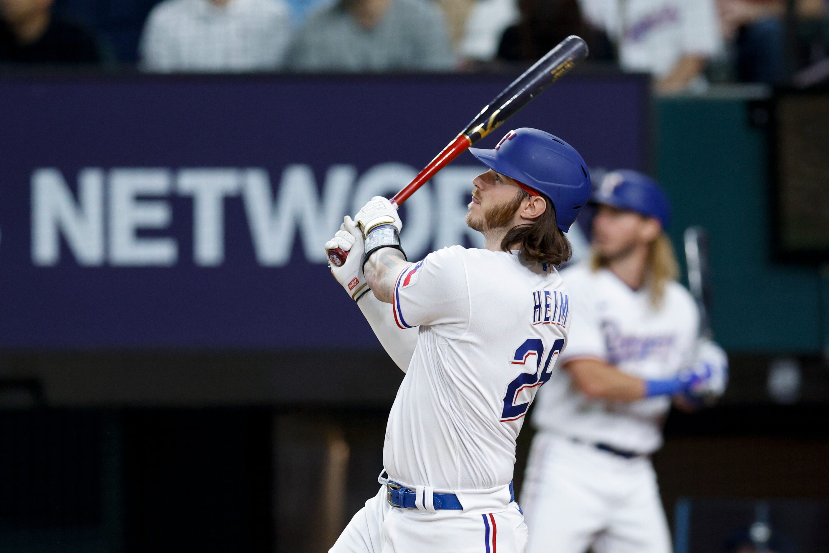 Texas Rangers catcher Jonah Heim (28) watches the ball after hitting a three-run walk-off...