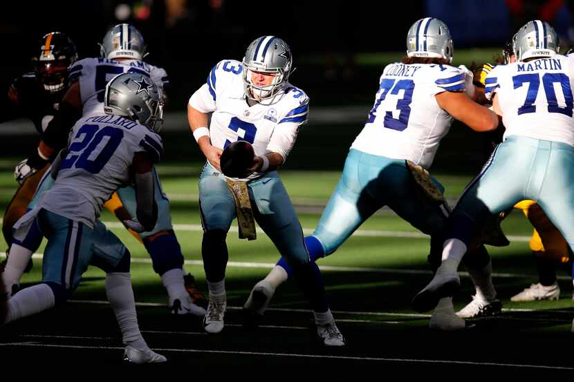 Dallas Cowboys quarterback Garrett Gilbert (3) hands the ball off to running back Tony...