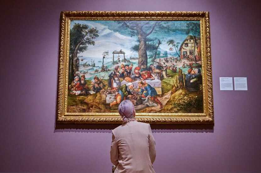 A visitor looks at Frans Verbeeck's "The Mocking of Human Follies" at the Dallas Museum of...