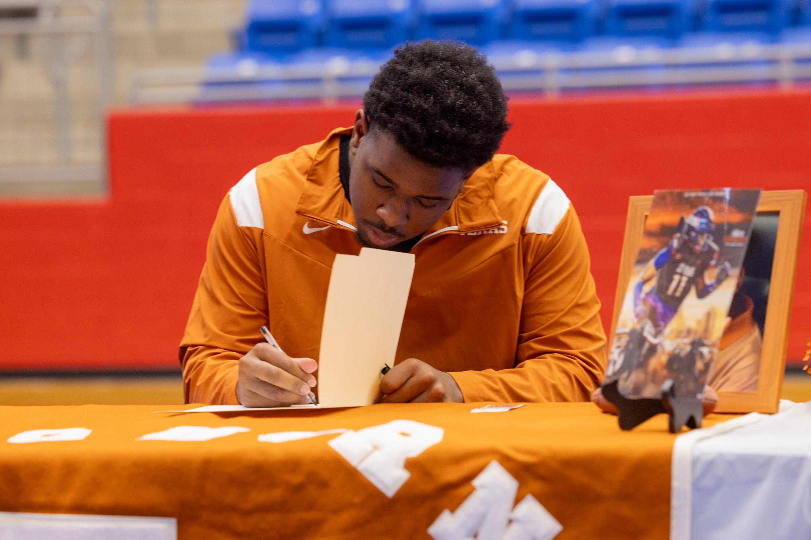 Defensive tackle Alex January signs his national letter of intent to play at the University...