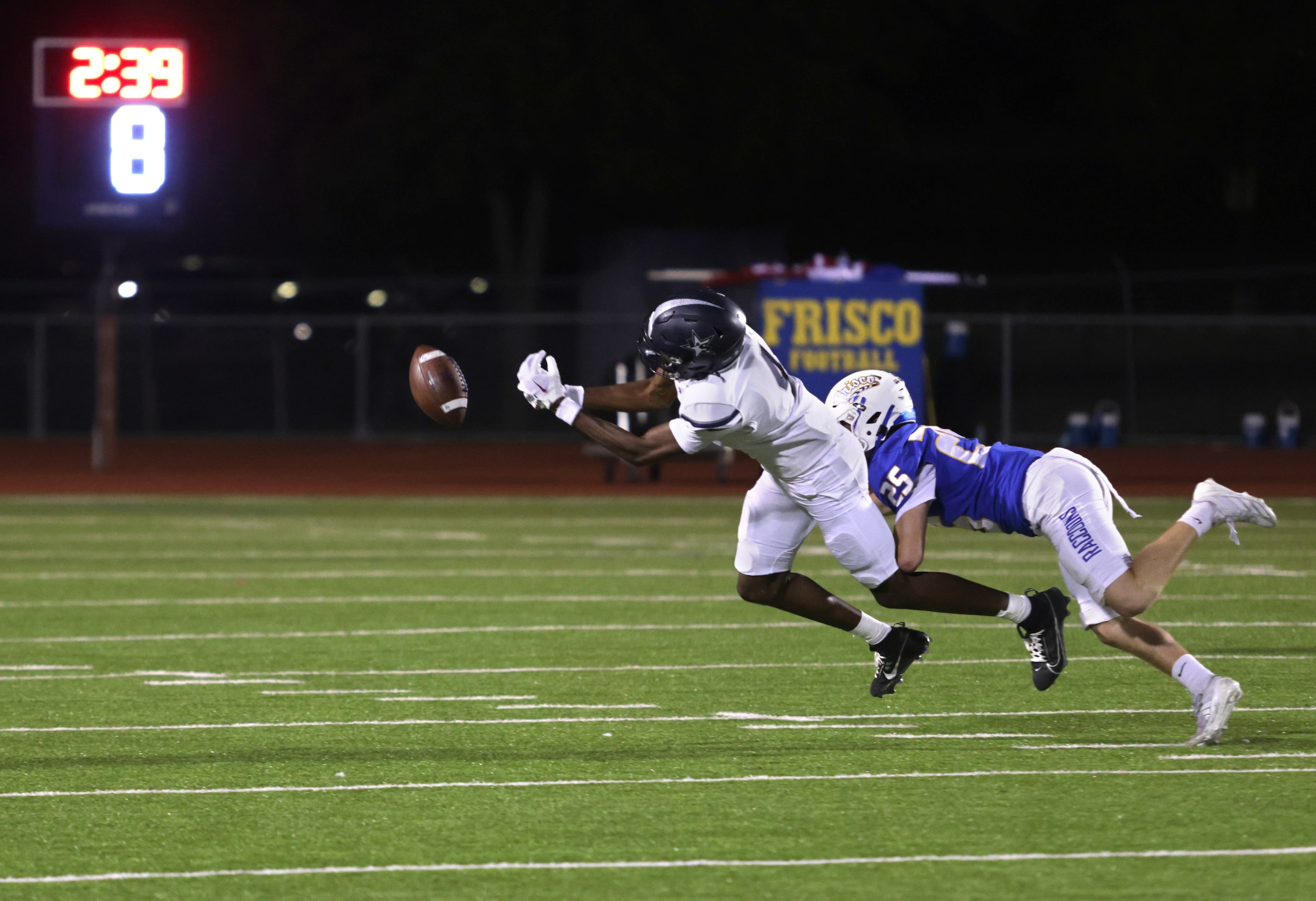 Frisco player #25 Hadi Hassan grabs onto Lone Star player #4 Bryson Jones as he jumps for...