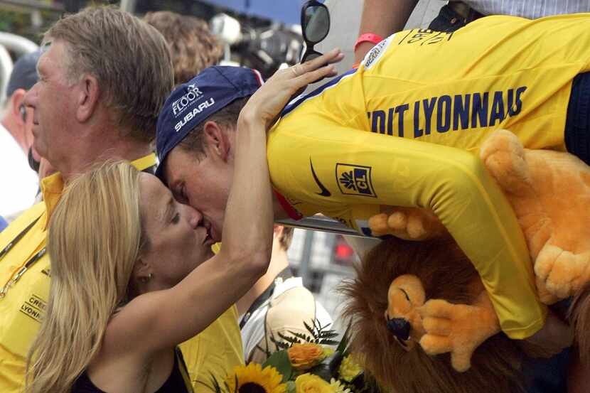 US Postal team rider Lance Armstrong is kissed by his girlfriend singer Sheryl Crow after...