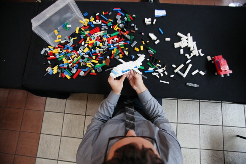 Lego builder Brandon Wike, 29, of Plano, constructs an airplane that would be part of his...