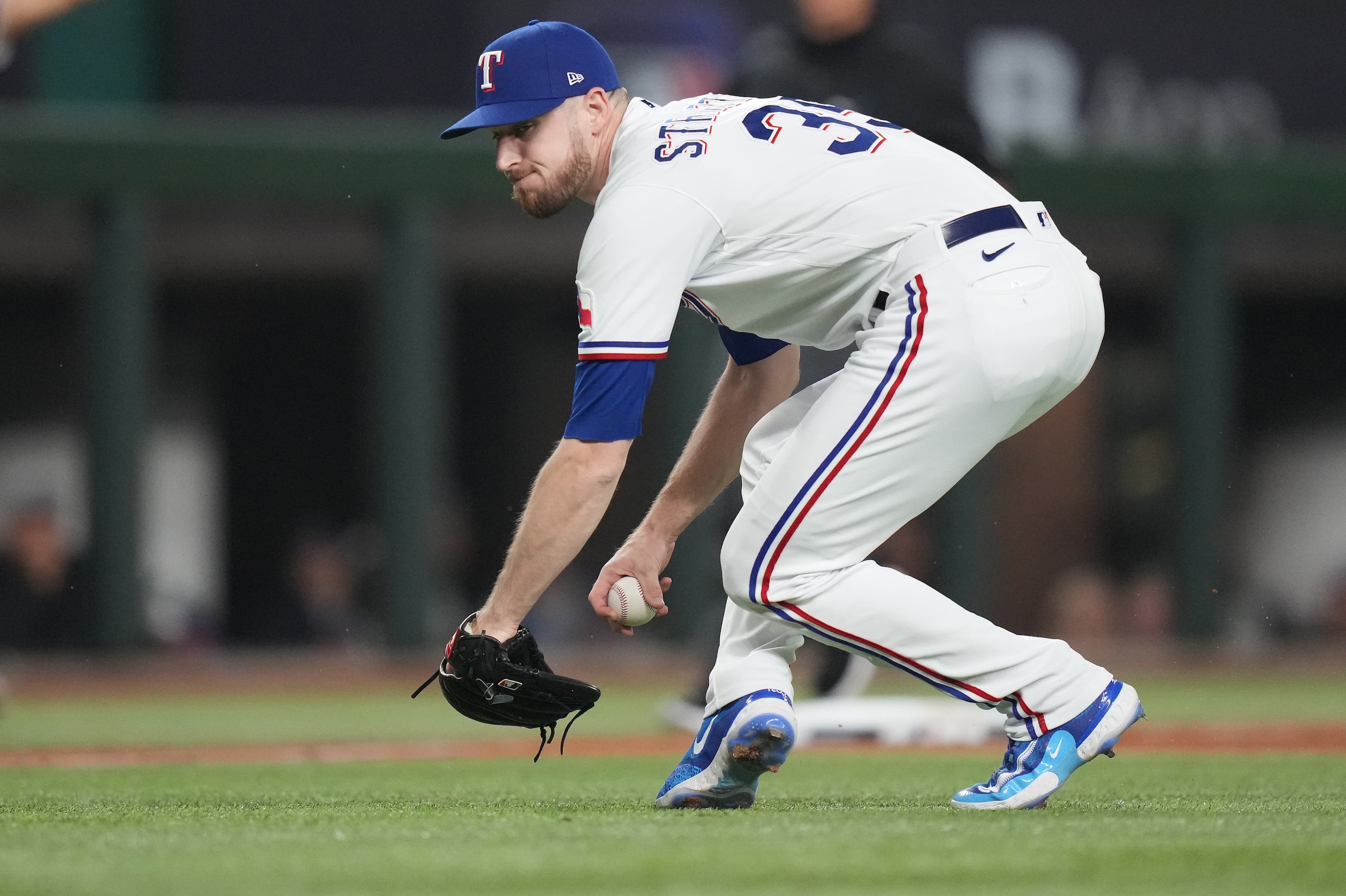 Texas Rangers relief pitcher Chris Stratton fields a sacrifice bunt by Arizona Diamondbacks'...