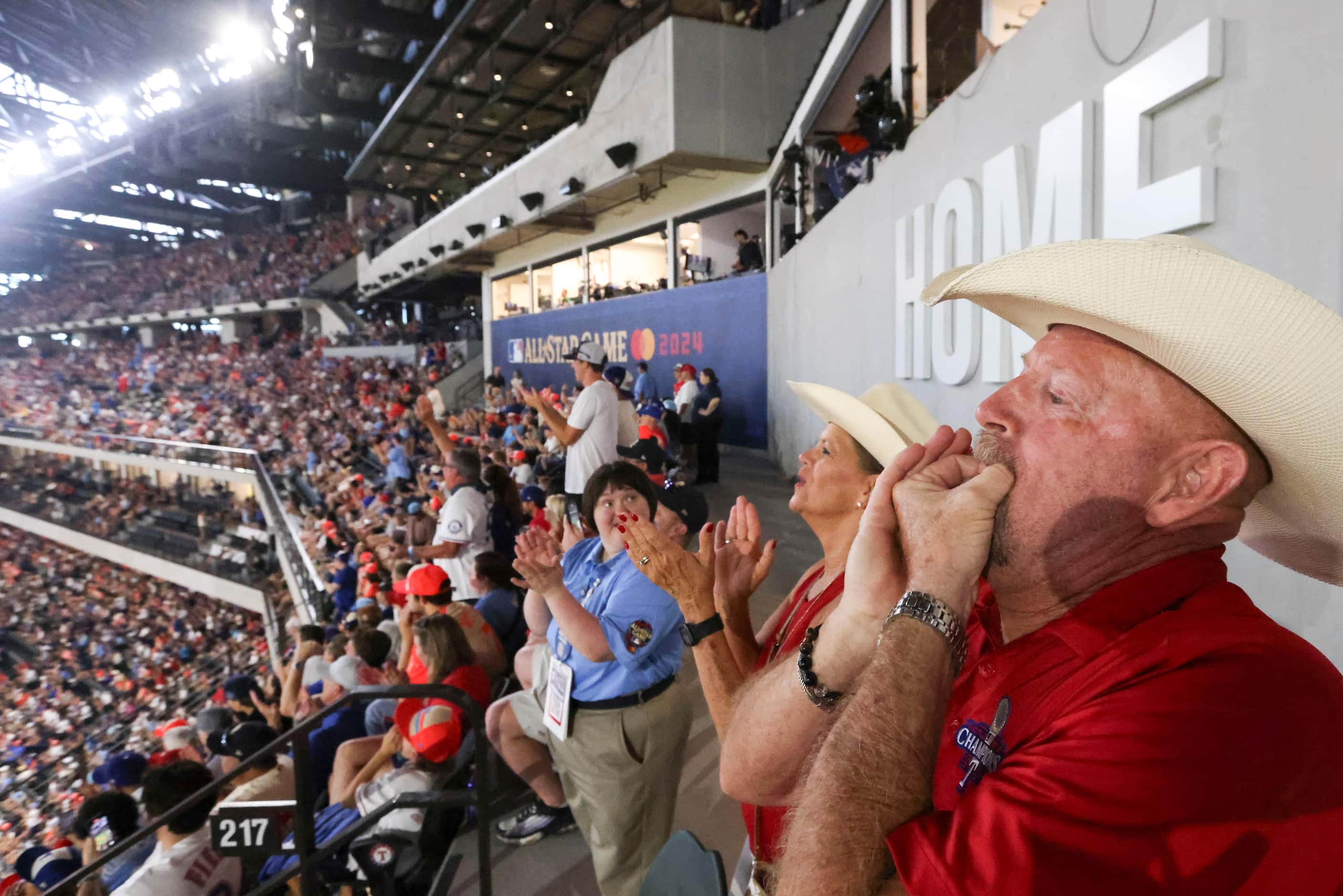 Texas Ranger season ticket holder Gary Gunter of Carrollton and his wife Patti Patak cheer...