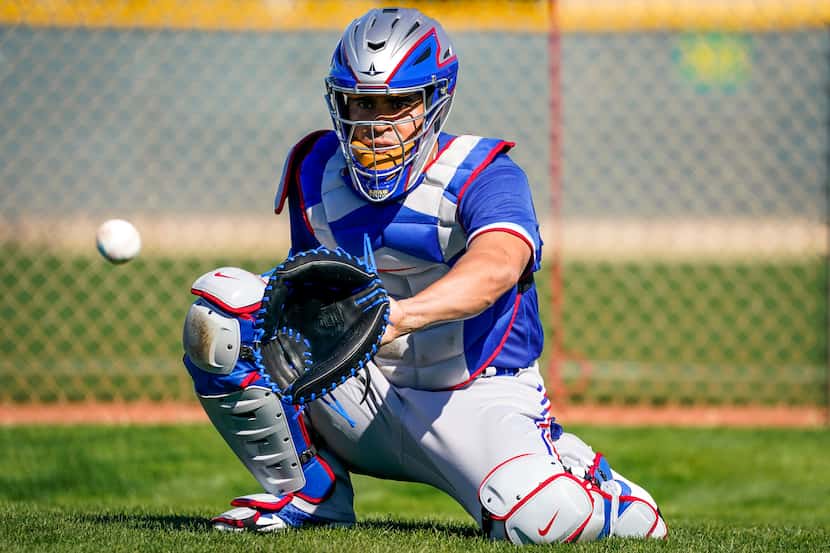 Texas Rangers catcher Robinson Chirinos  participates in a drill during a spring training...