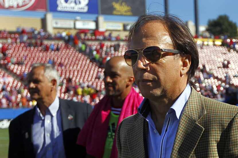 FC Dallas technical director Fernando Clavijo (with sunglasses walk off the field with head...