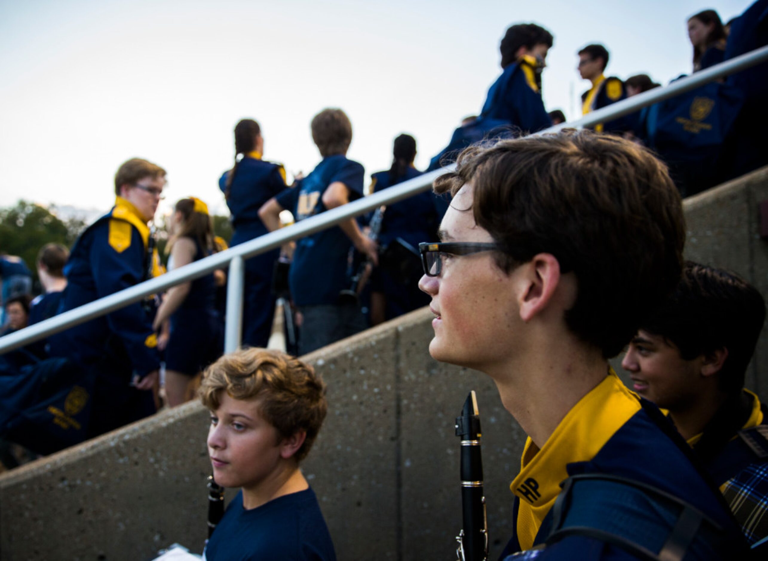 Highland Park band members make their way to their places in the stands before their game...