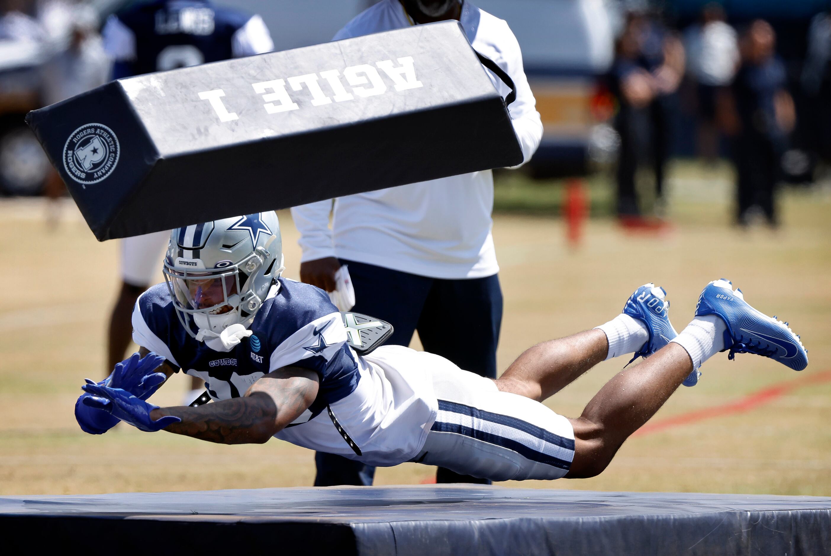 Dallas Cowboys cornerback Kyron Brown (26) dives for a blocking dummy and missed during a...