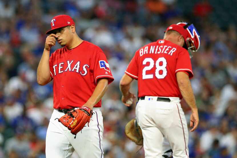 Texas Rangers starting pitcher Ariel Jurado (57) is relieved in the third inning of a...