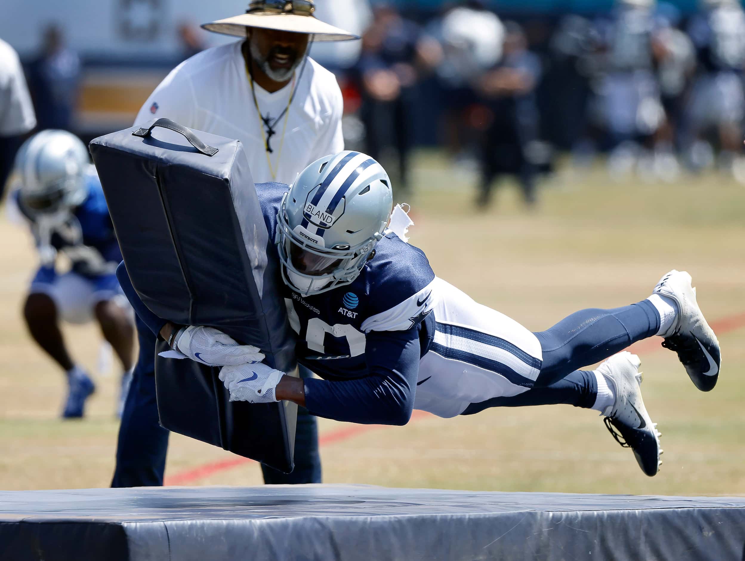 Dallas Cowboys rookie cornerback DaRon Bland (30)  dives and tackles a blocking dummy and...