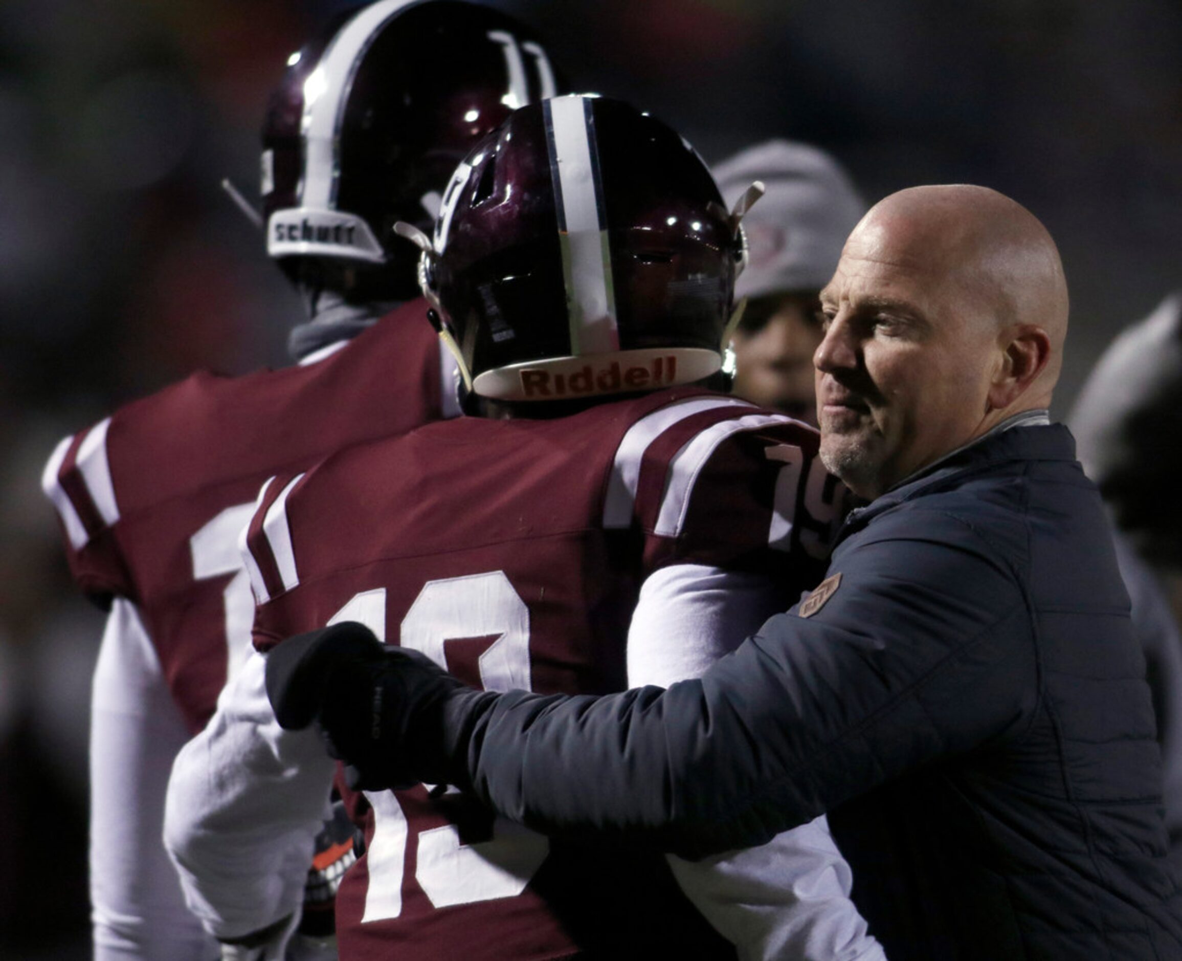 Red Oak team chaplain Jared Douglas welcomes Hawks receiver Coby Cavil (19) back to the team...