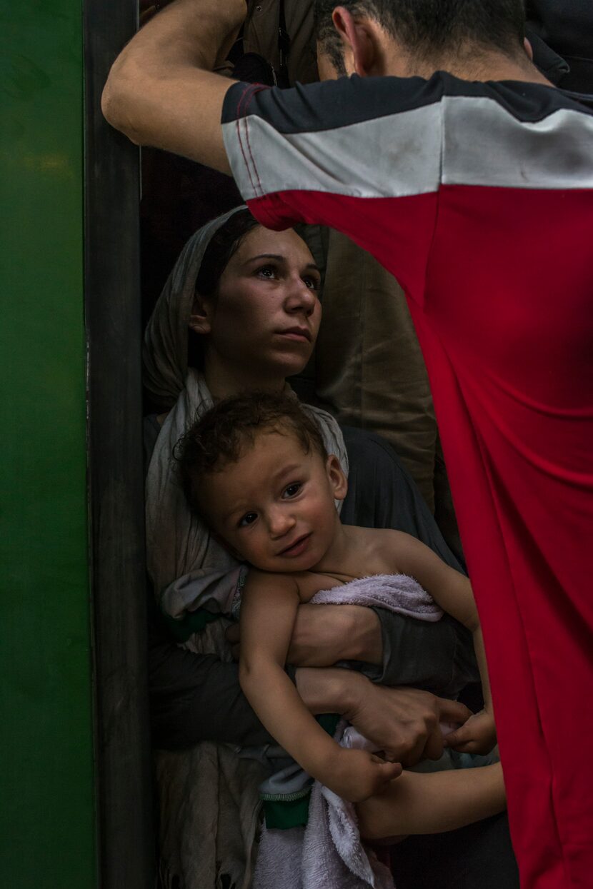 A migrant family waits for a train to leave at Keleti station in Budapest, Hungary, Sept. 3,...