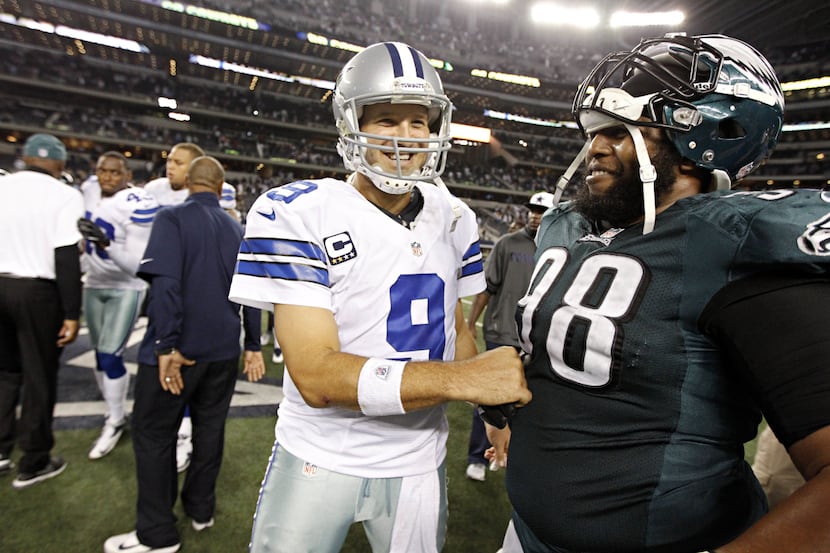 Dallas Cowboys quarterback Tony Romo (9) is all smiles as he greets Philadelphia Eagles...