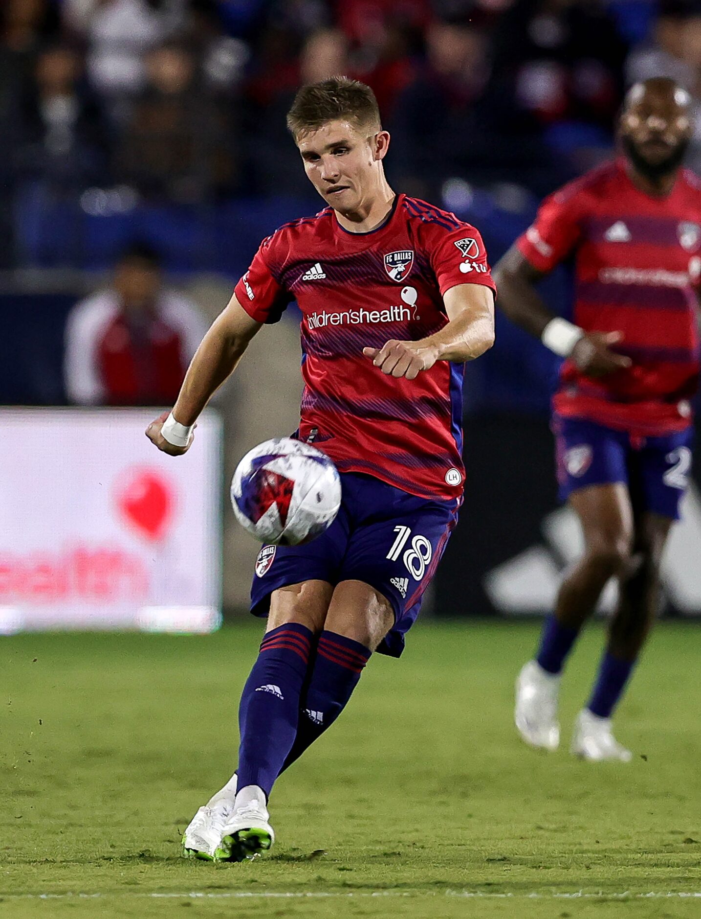 FC Dallas midfielder Liam Fraser kicks the ball down field against Seattle during the first...