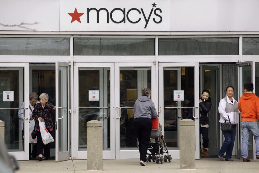 In this April 29, 2014 photo, shoppers enter and leave a Macy's department store in...