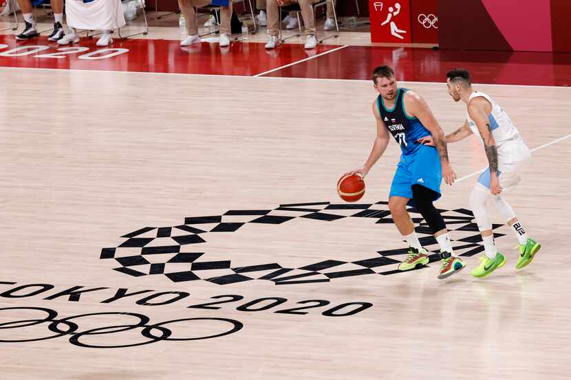 Slovenia’s Luka Doncic (77) brings the ball up the court as Argentina’s Luca Vildoza (17)...