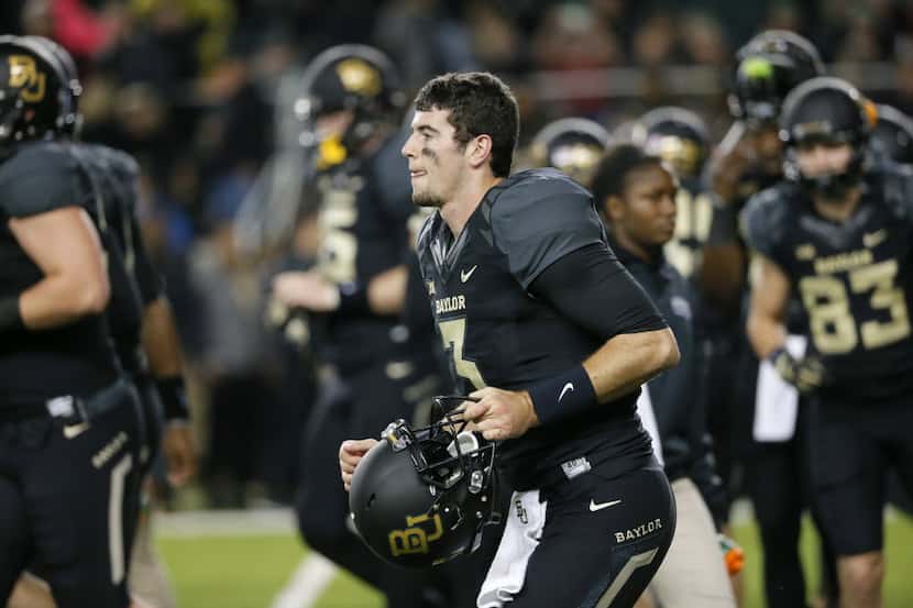 Baylor quarterback Jarrett Stidham warms up with the team before an NCAA college football...