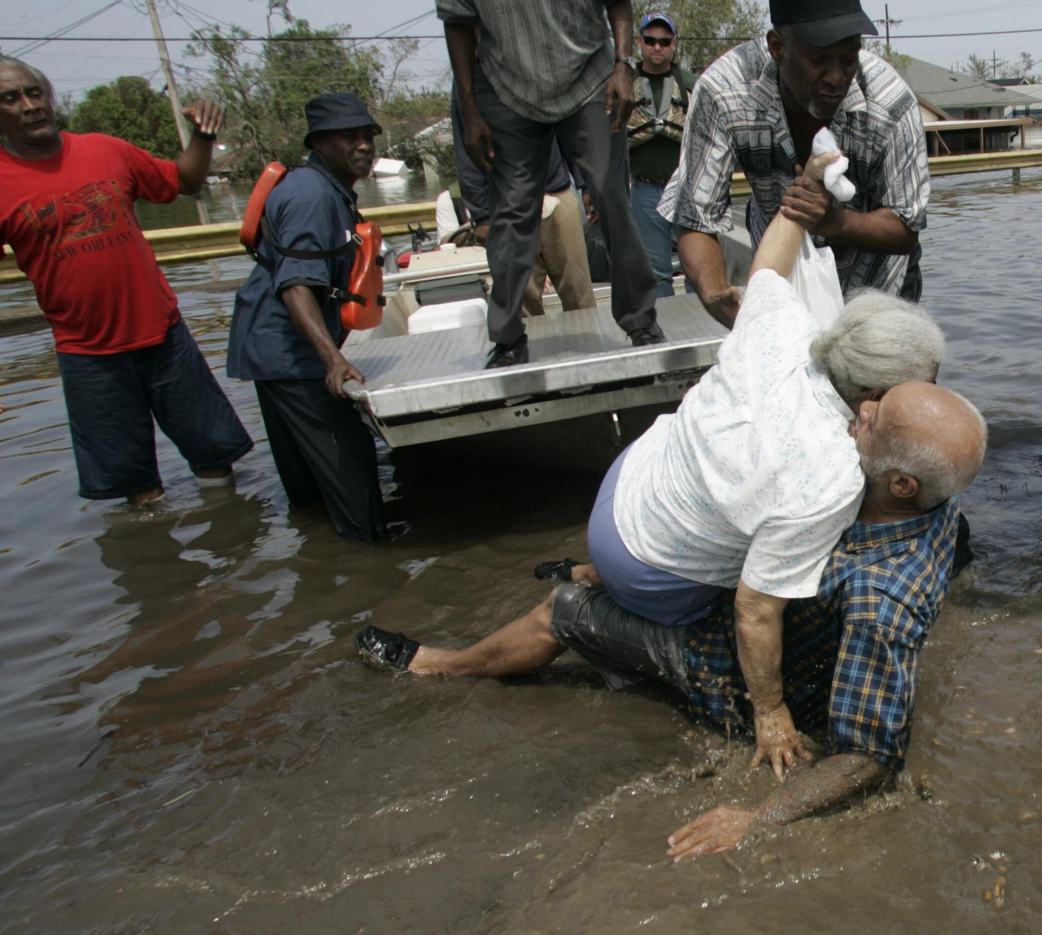 Ibry Smith (right) fell as he helped Norma Rankins out of a boat after they were rescued...