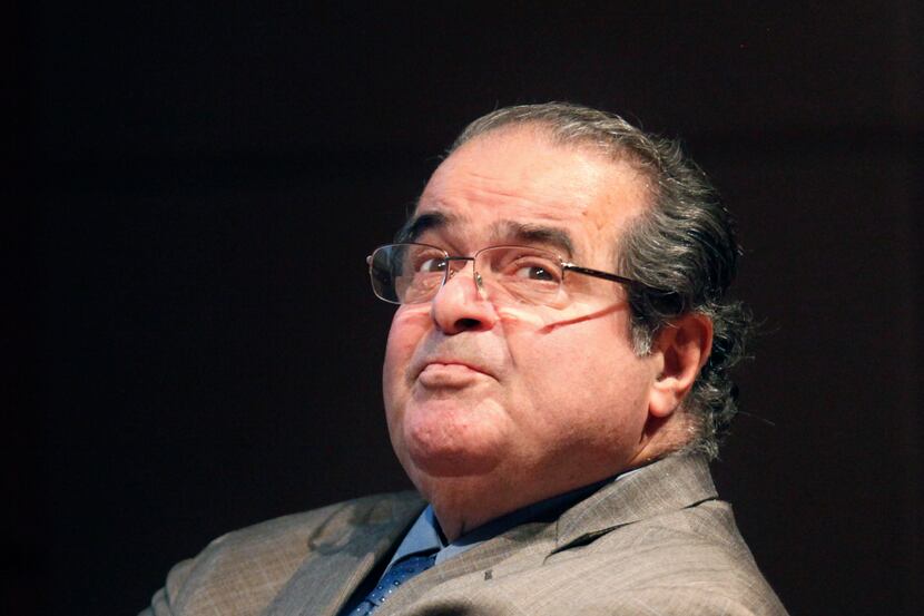 File, 2011: U.S. Supreme Court justice Antonin Scalia looks into the balcony before...