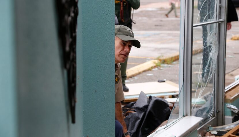 Texas Gov. Greg Abbott look at damage done to Mermaid's Kitchen as he visits Rockport, Texas...