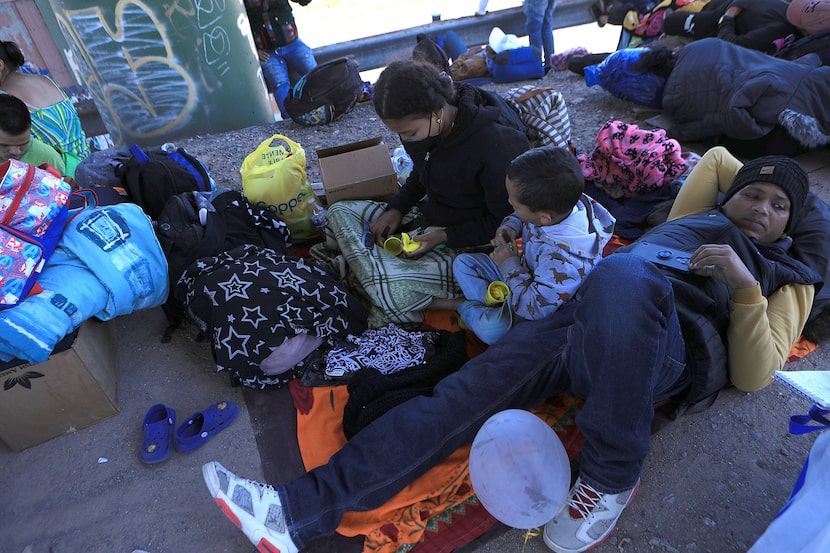 Juan Carlos Brito and his family wait below the Paso del Norte International Bridge that...