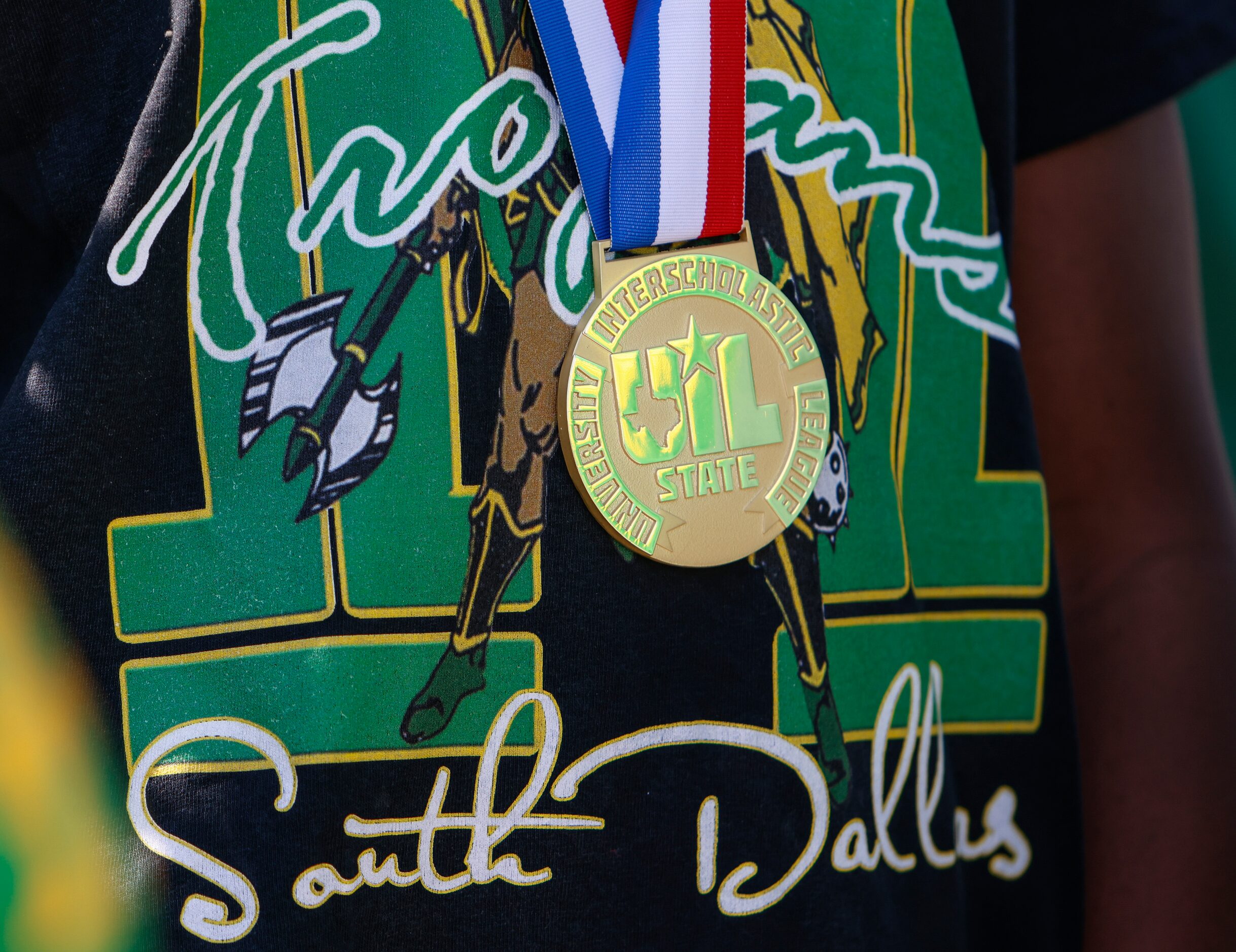 A James Madison High School basketball player wears a gold medal around his neck at the...