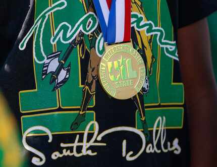 A Madison High School basketball player wears a gold medal around his neck at the Parade of...