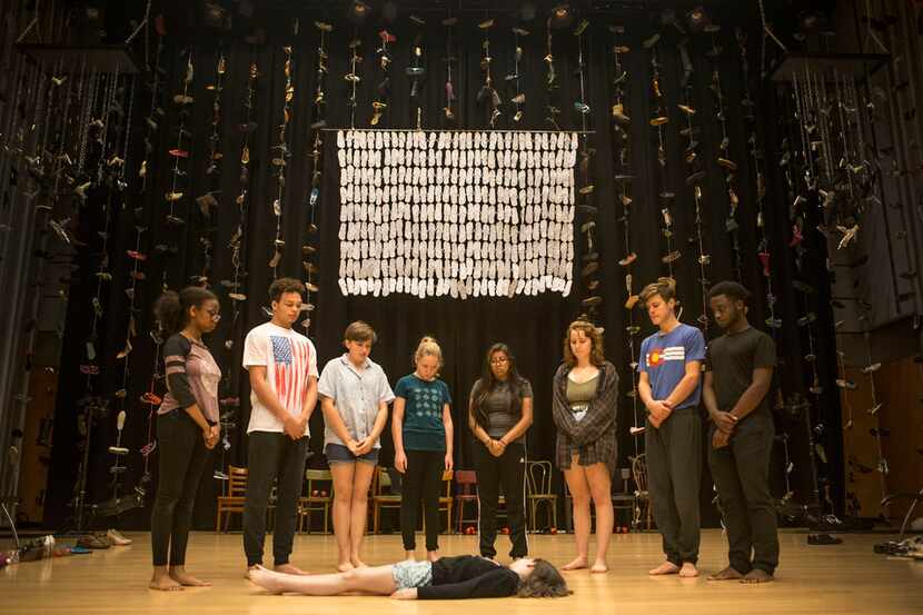 People surround Maren Bennett, 10, during a rehearsal of Cry Havoc Theater's Babel at the...