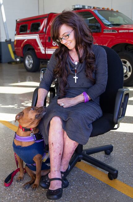 Danyeil Townzen pets her service dog, Cowboy. The pair was reunited after nearly 17 months...
